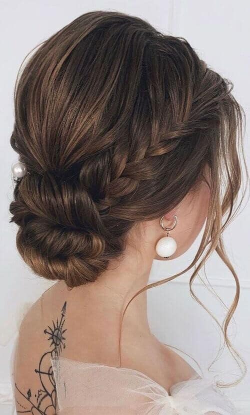 Braids inserted into a low bun