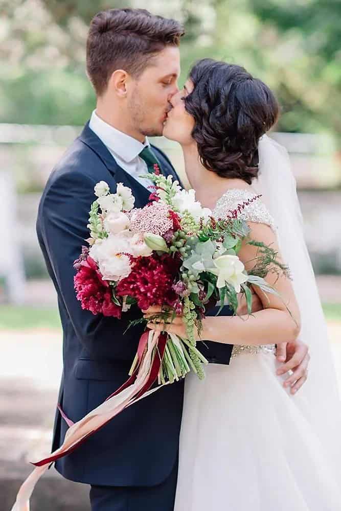 White And Burgundy Flowers In Greenery Bouquets