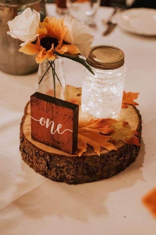 Fairy lights, sunflowers, and log slices