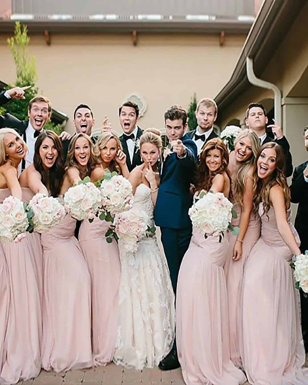 Group Shot Of Bride, Groom, Family And Wedding Party