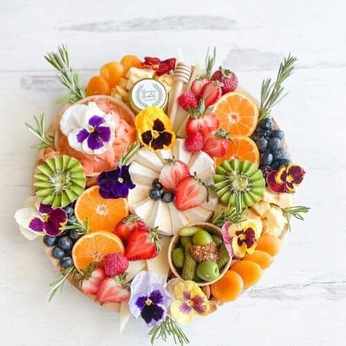 Fruit and cheese board with flowers