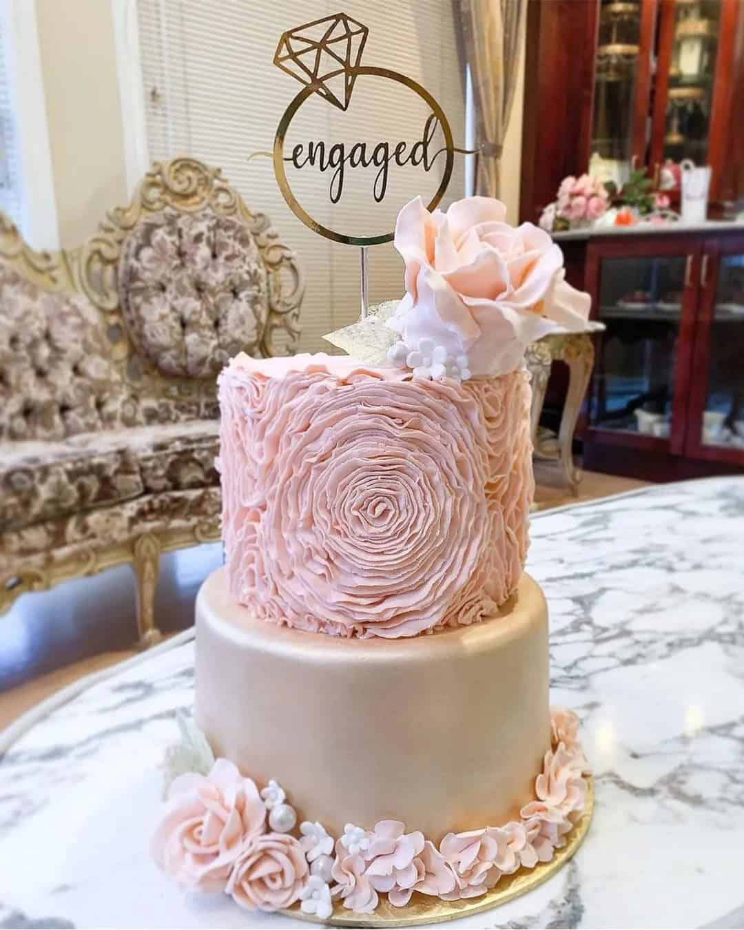 “We’re so engaged” cake topper