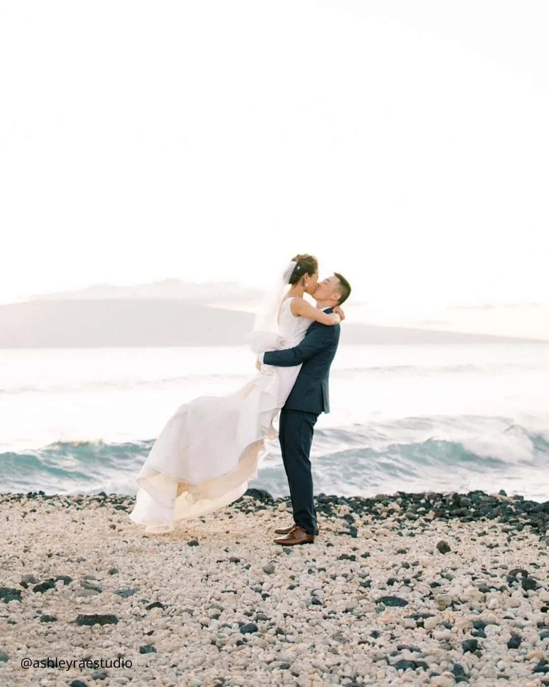 Groom Holds Bride In His Arms And Kisses