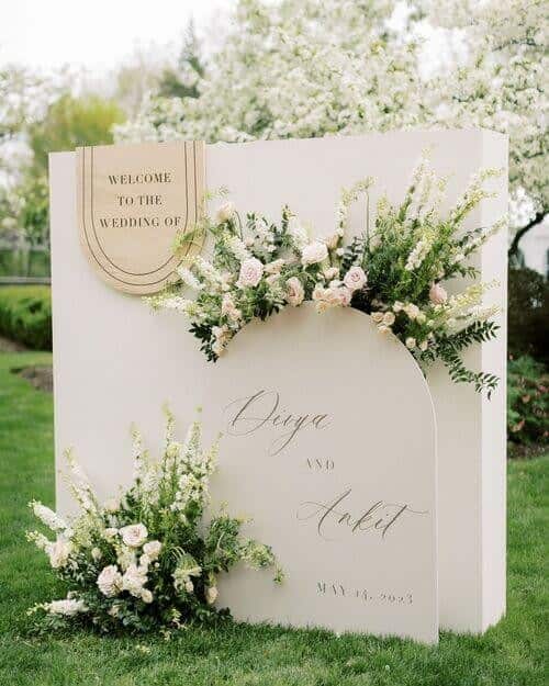 Tiered welcome sign with flowers