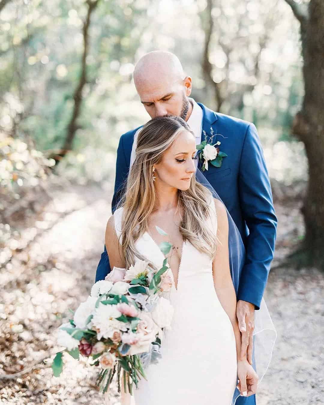 The Groom Kisses Bride’s Forehead Tenderly