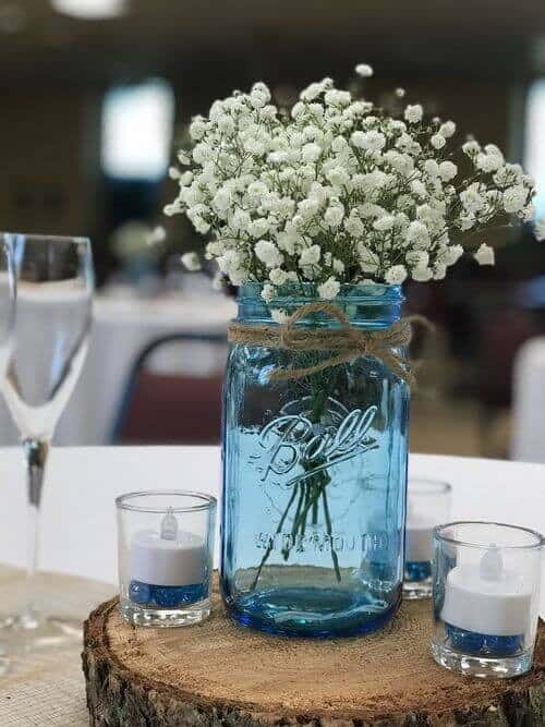 Tinted mason jars filled with baby’s breath