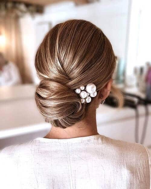 A slicked-back low bun