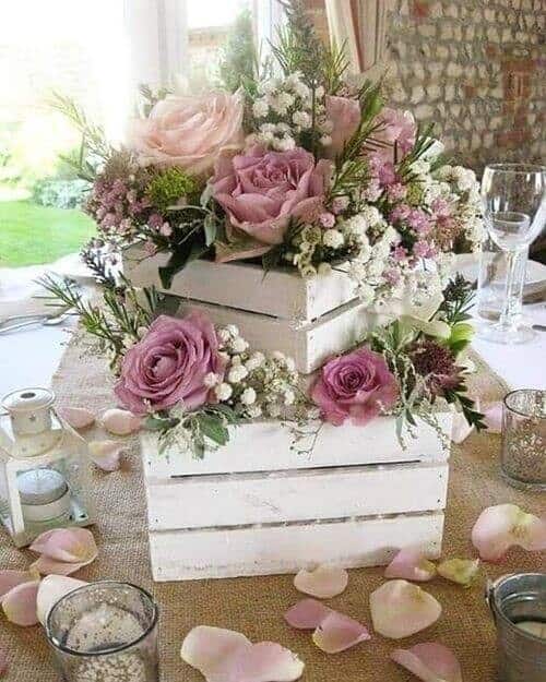 Wooden boxes filled with pink blossoms