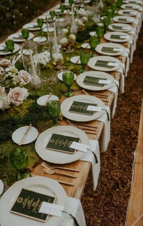 Moss-covered tables and blush-pink roses