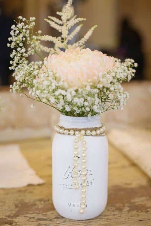 White mason jars wrapped in pearls and burlap