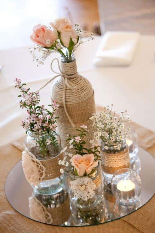 Twine and burlap-wrapped jars filled with flowers