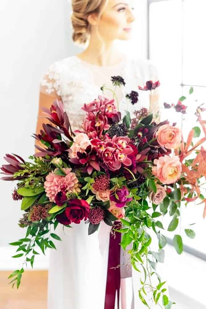 White And Burgundy Flowers In Greenery Bouquets