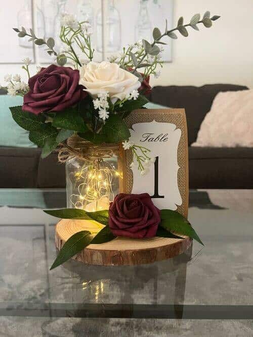 Purple and white roses in mason jars