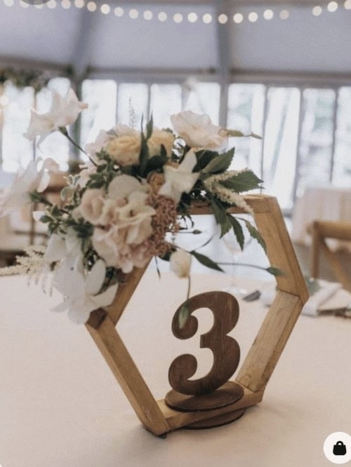 Table numbers in hexagons wrapped in flowers