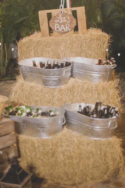 Galvanised steel basins as wedding coolers on hay stands