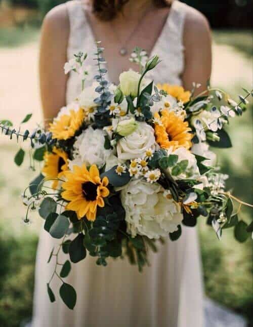 Sunflower, eucalyptus, and white roses