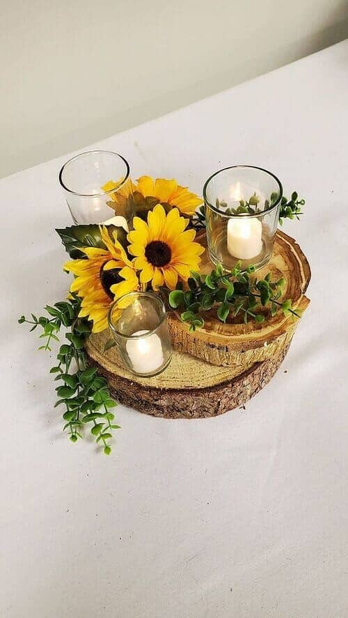 Candles, greenery, and sunflower centerpieces