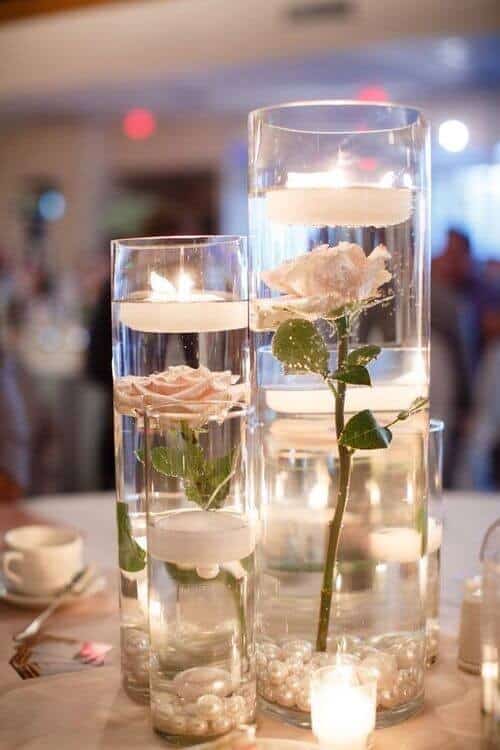 White roses in filled jars