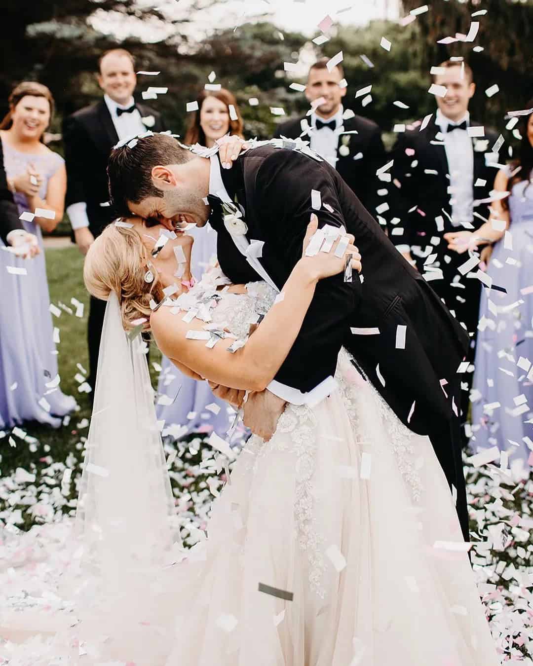 Wedding Kiss On A Background Of Happy Guests