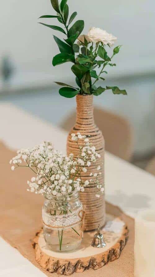 Roses in twine-wrapped wine bottles