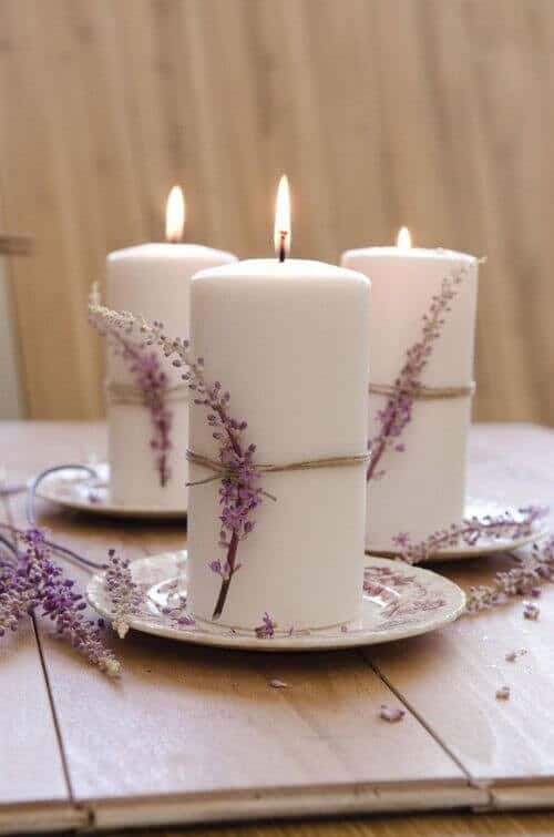 White candles wrapped in twine and lavender