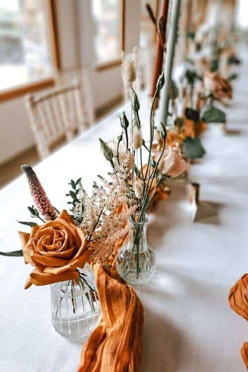 Orange table runners and greenery