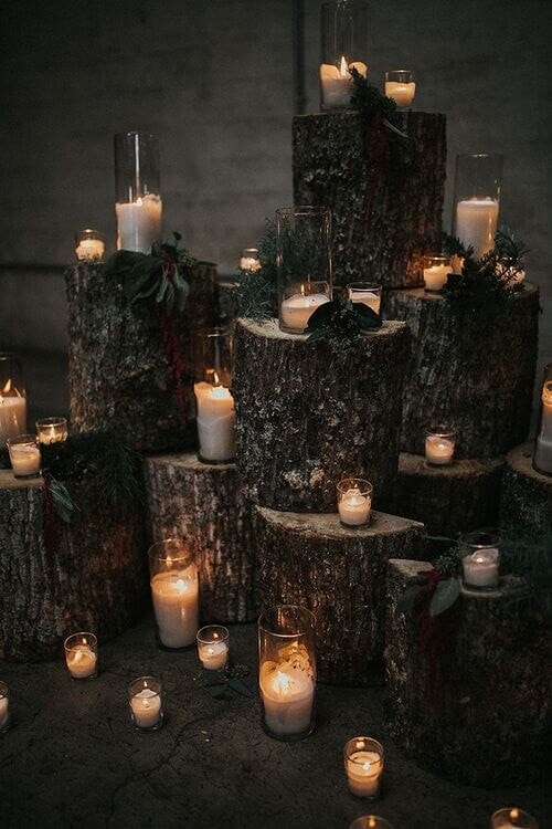 Dark wood log pieces and white candle decor