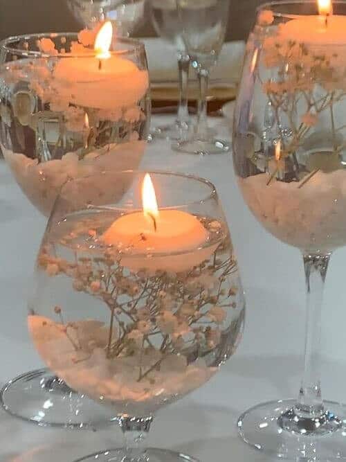 Floating candles in wine glasses