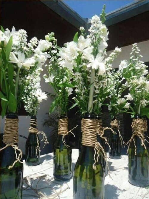 White flowers in wine bottles