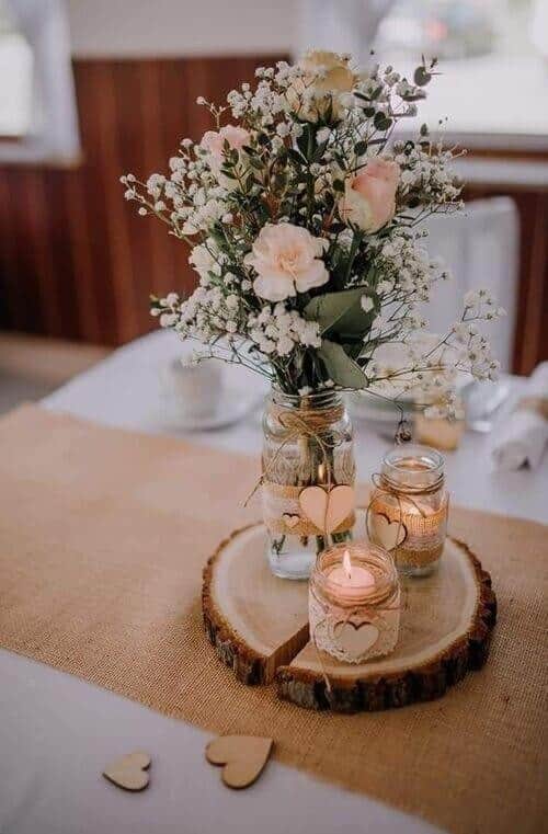 Twine-wrapped jars filled with roses